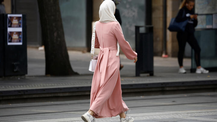 A Muslim woman, wearing the style of dress called an abaya, walks in a street in Nantes, France, August 29, 2023. 